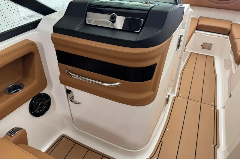 Slide: The Image of 2026 Chaparral 250 OSX boat interior with tan seating and sleek design. - 19