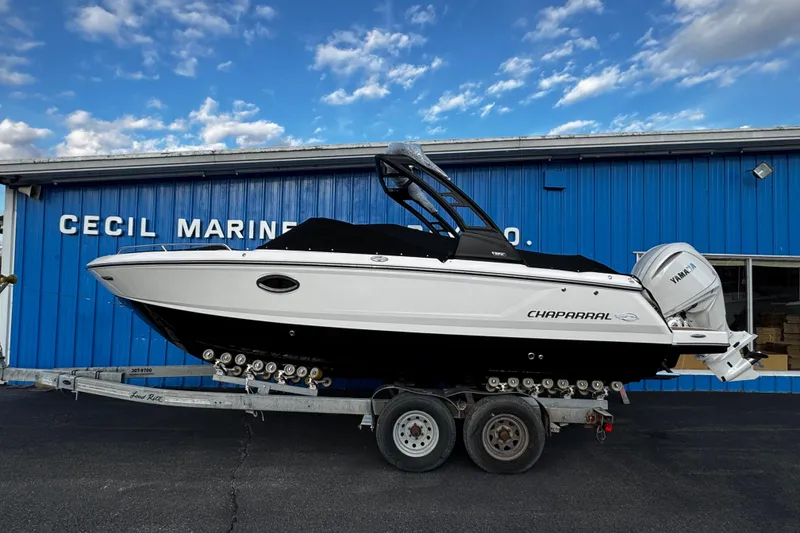 Slide: The Image of 2026 Chaparral 250 OSX boat on trailer at Cecil Marine, blue sky background. - 2
