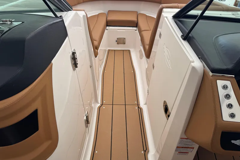 Slide: The Image of 2026 Chaparral 250 OSX boat interior with tan seating and sleek design. - 21