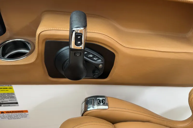 Slide: The Image of Throttle control and cup holder in 2026 Chaparral 250 OSX boat interior. - 23