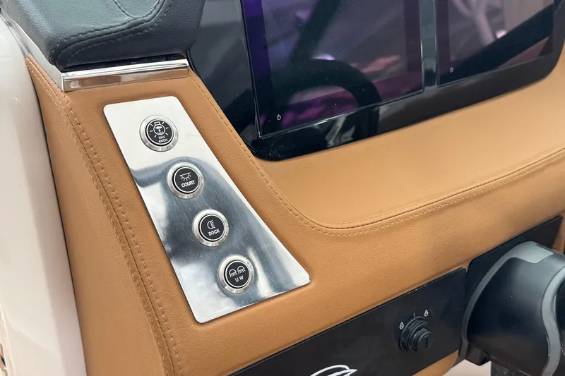 Slide: The Image of Control panel of 2026 Chaparral 250 OSX boat with leather trim and buttons. - 24
