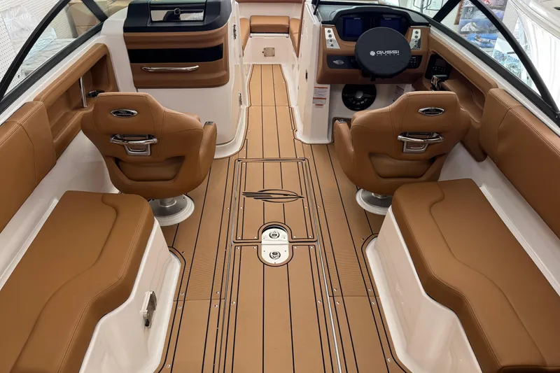 Slide: The Image of Interior of 2026 Chaparral 250 OSX boat with luxurious tan seating and modern dashboard. - 3