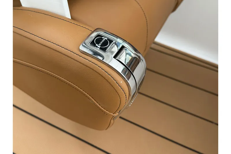 Slide: The Image of 2026 Chaparral 250 OSX boat throttle control on tan leather seat. - 30