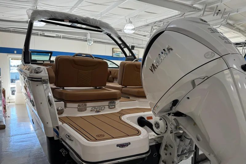 Slide: The Image of 2026 Chaparral 250 OSX boat with Yamaha engine, featuring luxurious brown seating. - 4