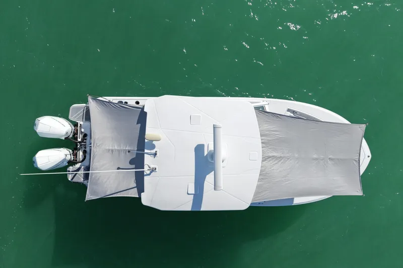 Slide: The Image of Overhead view of 2022 Blackfin 272 DC boat on green water. - 10