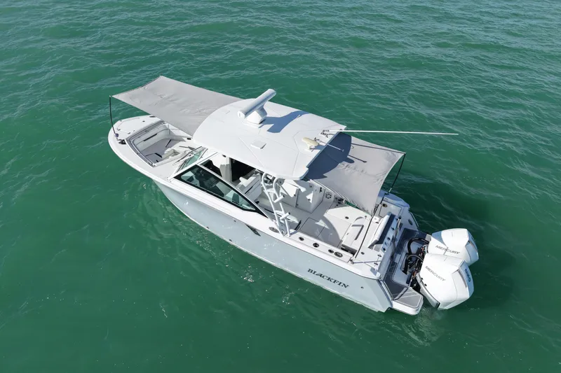 Slide: The Image of 2022 Blackfin 272 DC boat with canopy on open water, aerial view. - 11