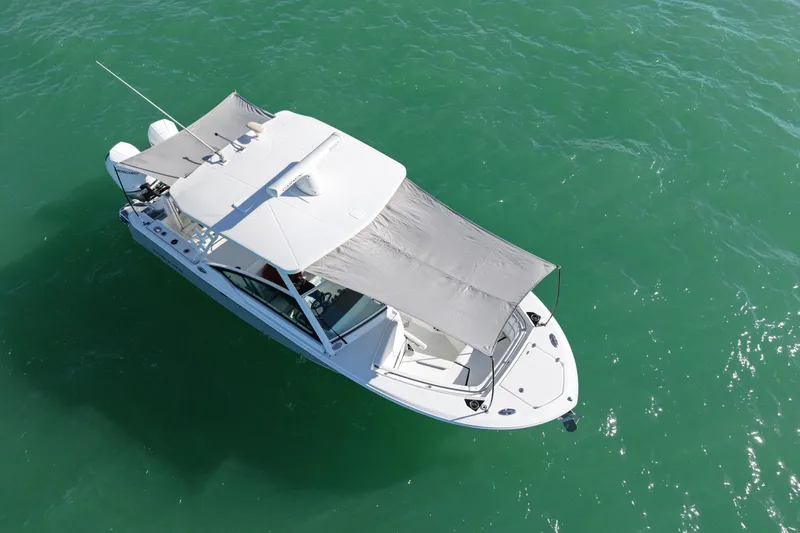 Slide: The Image of Aerial view of 2022 Blackfin 272 DC boat on clear green water. - 12
