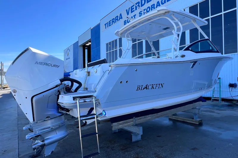 Slide: The Image of 2022 Blackfin 272 DC boat with Mercury engine at storage facility. - 17