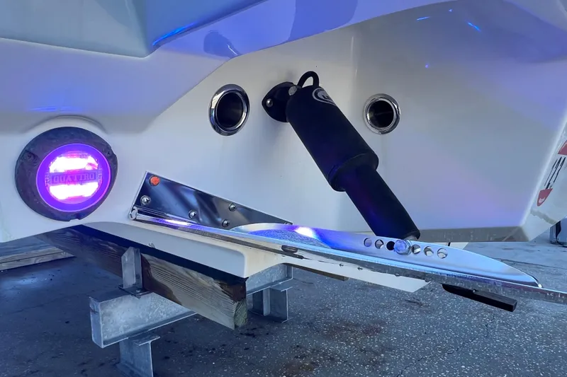 Slide: The Image of 2022 Blackfin 272 DC boat stern with illuminated underwater light and trim tab. - 20
