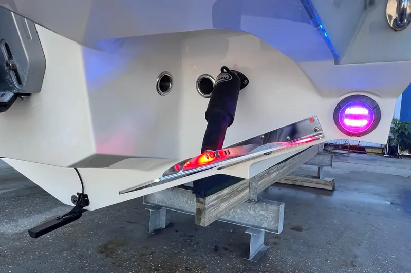 Slide: The Image of 2022 Blackfin 272 DC boat stern with illuminated trim tabs and underwater lights. - 21