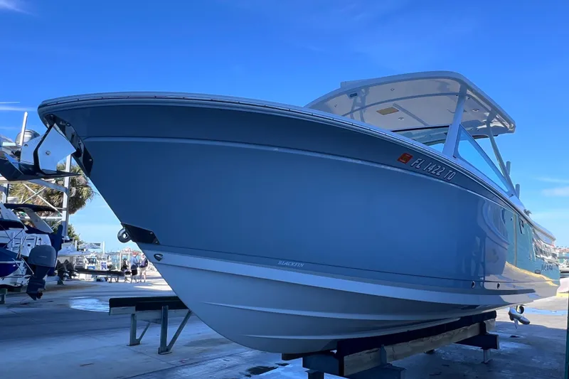 Slide: The Image of 2022 Blackfin 272 DC boat on display, sleek design, marina background. - 22