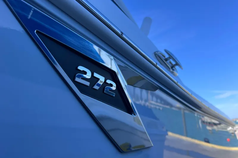 Slide: The Image of Close-up of 2022 Blackfin 272 DC boat emblem against a clear blue sky. - 28