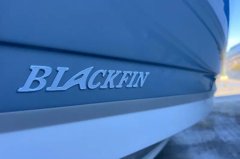 Slide: The Image of Close-up of 2022 Blackfin 272 DC boat logo on hull. - 29