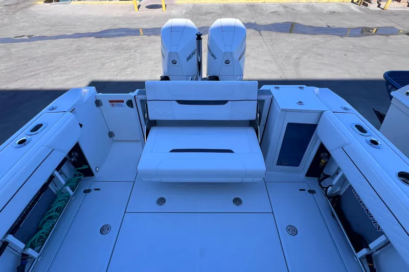 Slide: The Image of 2022 Blackfin 272 DC boat interior with dual Mercury engines, spacious seating, and storage compartments. - 36