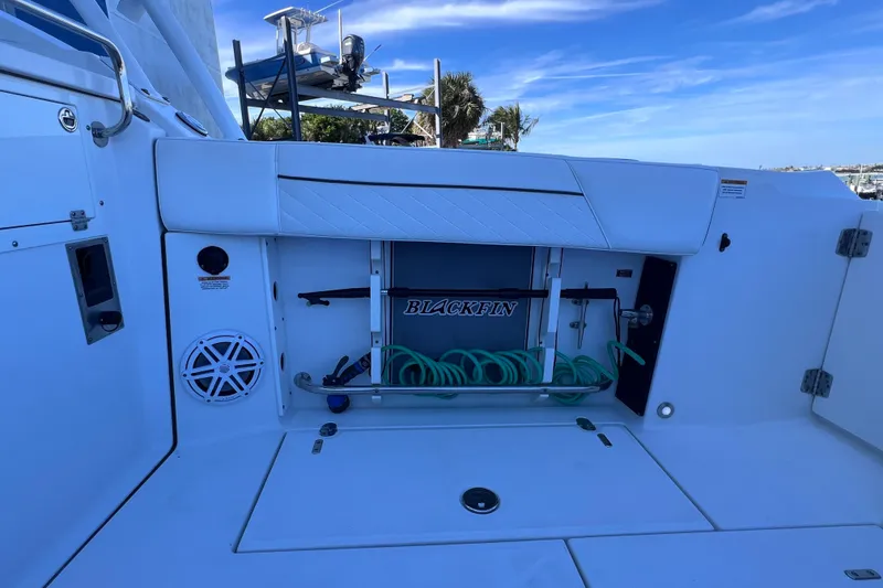 Slide: The Image of 2022 Blackfin 272 DC boat deck with storage compartment and coiled hose. - 38