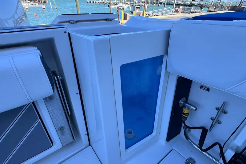 Slide: The Image of 2022 Blackfin 272 DC boat interior with raw water access and seating, dockside view. - 39