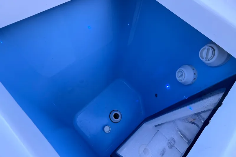 Slide: The Image of 2022 Blackfin 272 DC boat livewell with blue interior and water filtration system. - 40