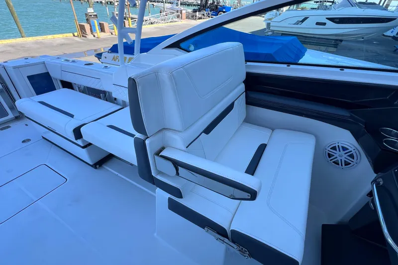 Slide: The Image of 2022 Blackfin 272 DC boat interior with white seating and waterfront view. - 48