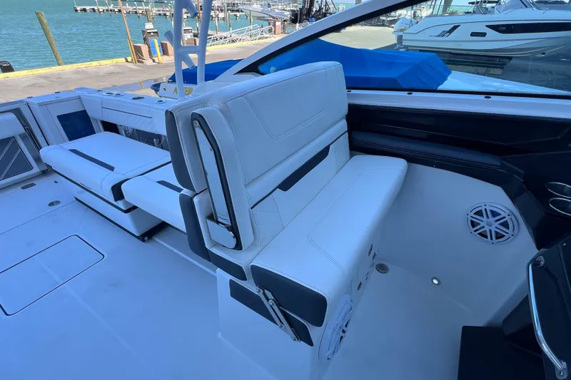 Slide: The Image of 2022 Blackfin 272 DC boat interior with white seating and waterfront view. - 49
