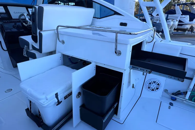 Slide: The Image of 2022 Blackfin 272 DC boat interior with storage compartments and seating. - 51