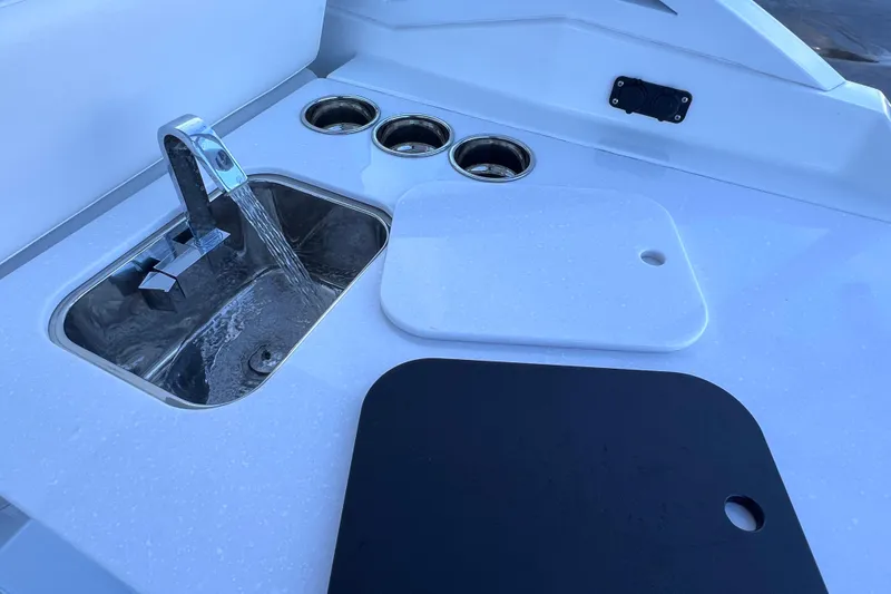 Slide: The Image of 2022 Blackfin 272 DC boat sink with running water and cutting boards. - 53