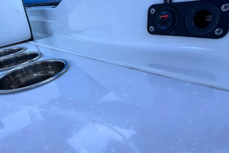 Slide: The Image of 2022 Blackfin 272 DC boat interior with cup holders and USB charging port. - 55