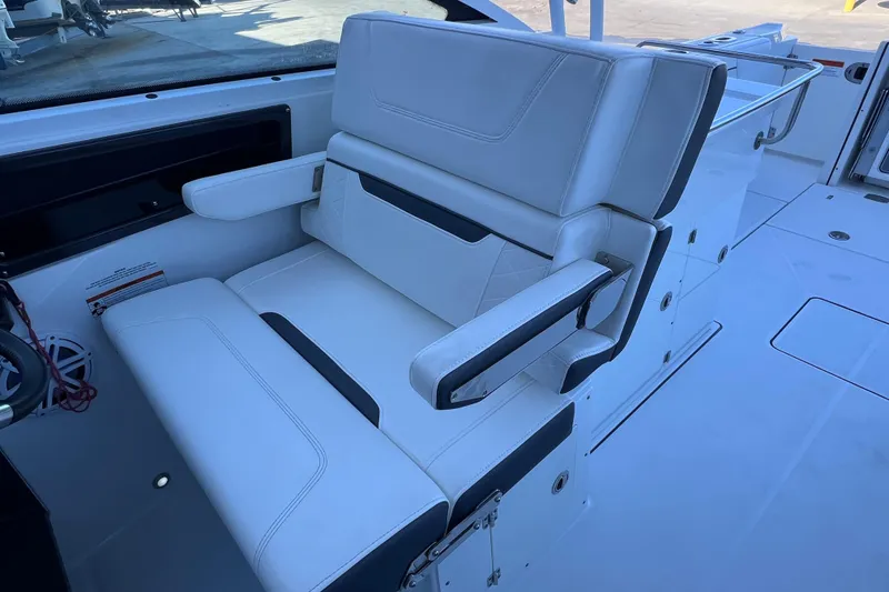 Slide: The Image of Luxury seating on 2022 Blackfin 272 DC boat, featuring white upholstery and armrests. - 56