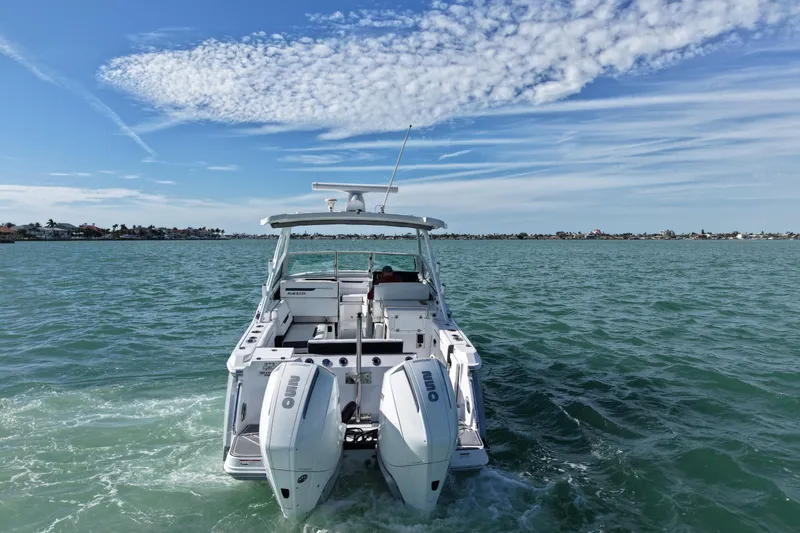 Slide: The Image of 2022 Blackfin 272 DC boat cruising on open water under a partly cloudy sky. - 7