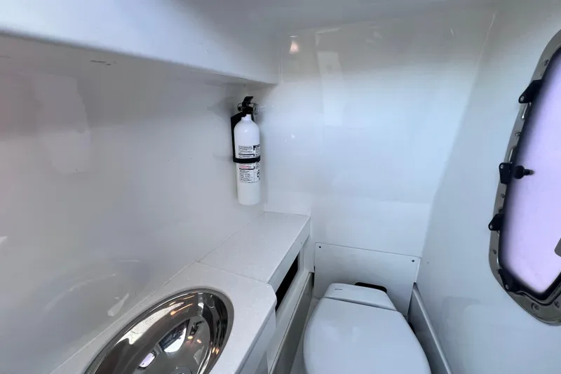 Slide: The Image of 2022 Blackfin 272 DC boat interior with toilet, sink, and fire extinguisher. - 75