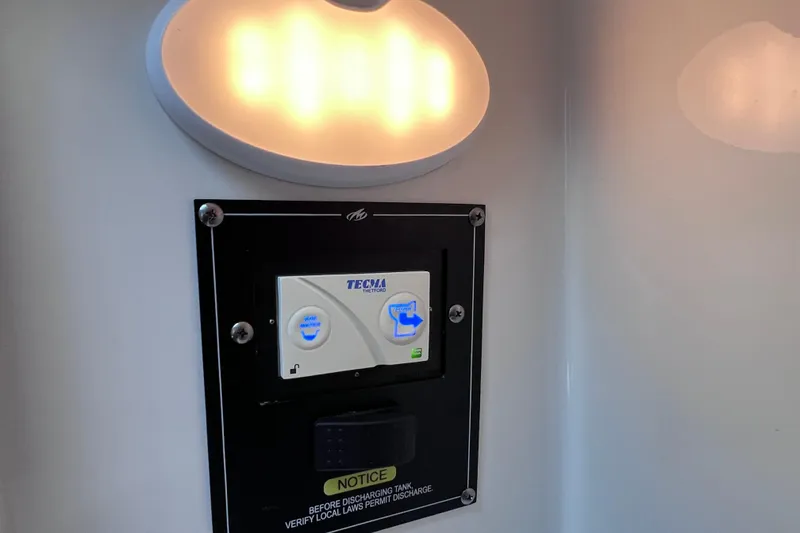 Slide: The Image of Control panel on 2022 Blackfin 272 DC boat with illuminated light above. - 76