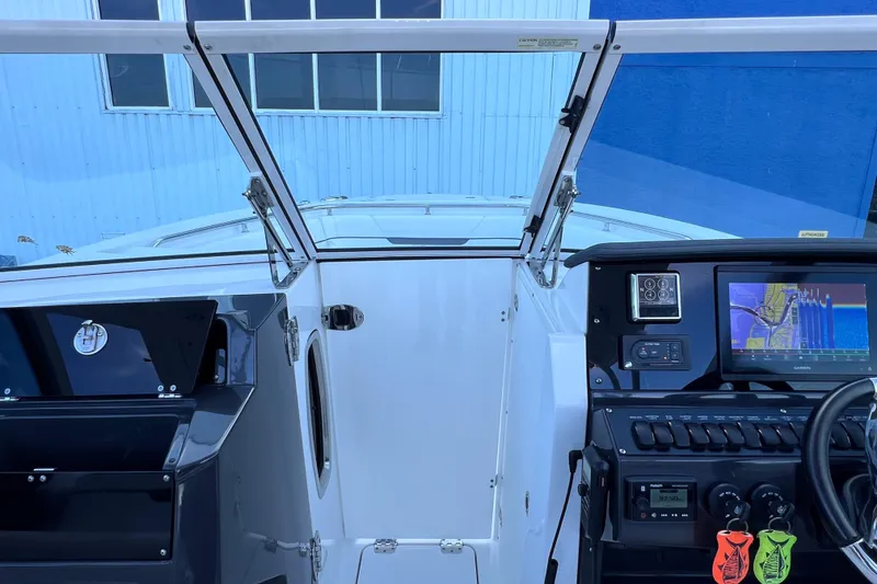 Slide: The Image of 2022 Blackfin 272 DC boat dashboard with navigation system and controls. - 80