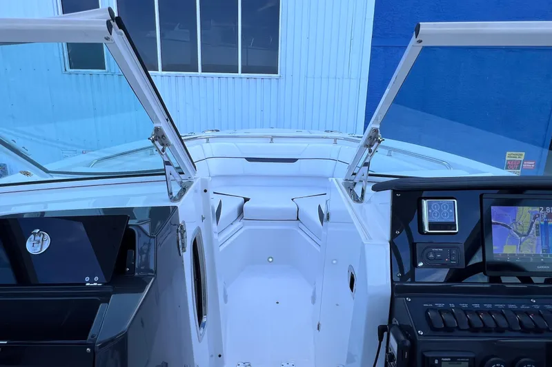 Slide: The Image of 2022 Blackfin 272 DC boat interior with open windshield and navigation system. - 81