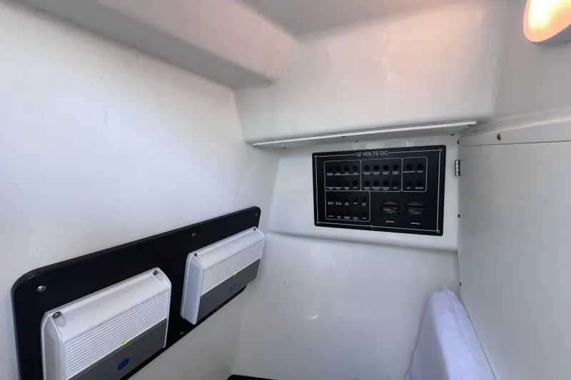 Slide: The Image of 2022 Blackfin 272 DC interior showing electrical panel and lighting controls. - 83