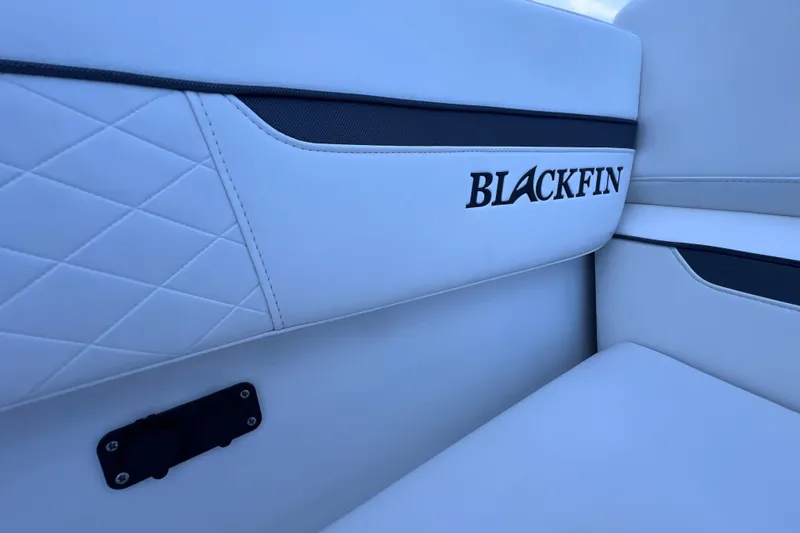 Slide: The Image of 2022 Blackfin 272 DC boat interior with white quilted upholstery and logo. - 86