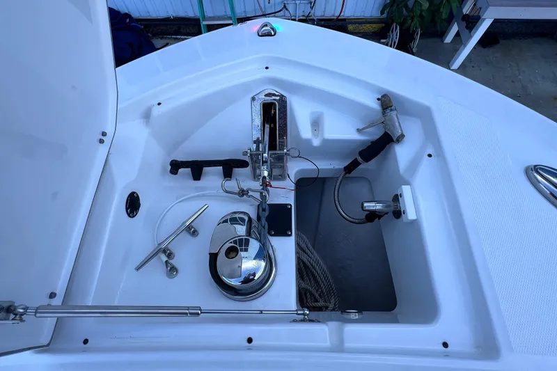 Slide: The Image of Anchor compartment of 2022 Blackfin 272 DC boat, featuring winch and rope storage. - 89