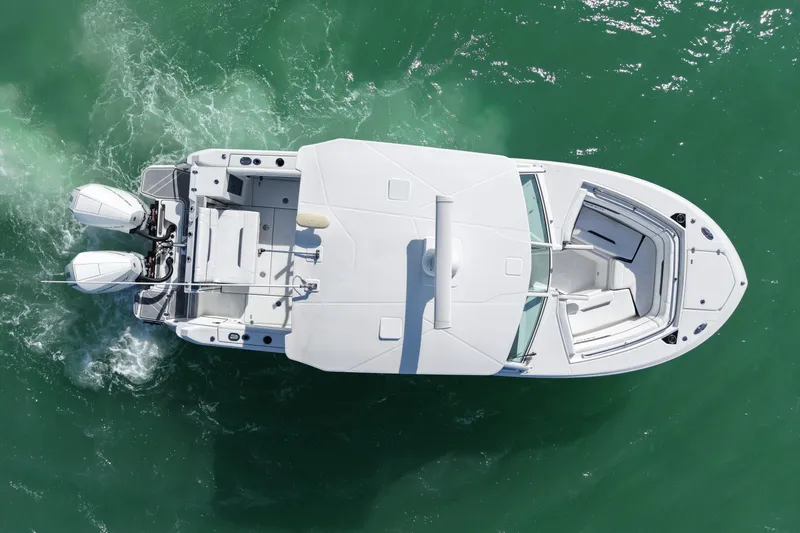 Slide: The Image of Overhead view of 2022 Blackfin 272 DC boat cruising on green water. - 9