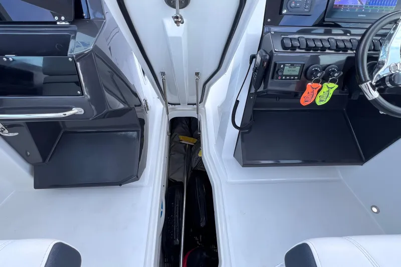 Slide: The Image of Interior view of 2022 Blackfin 272 DC boat cockpit with modern controls and seating. - 91