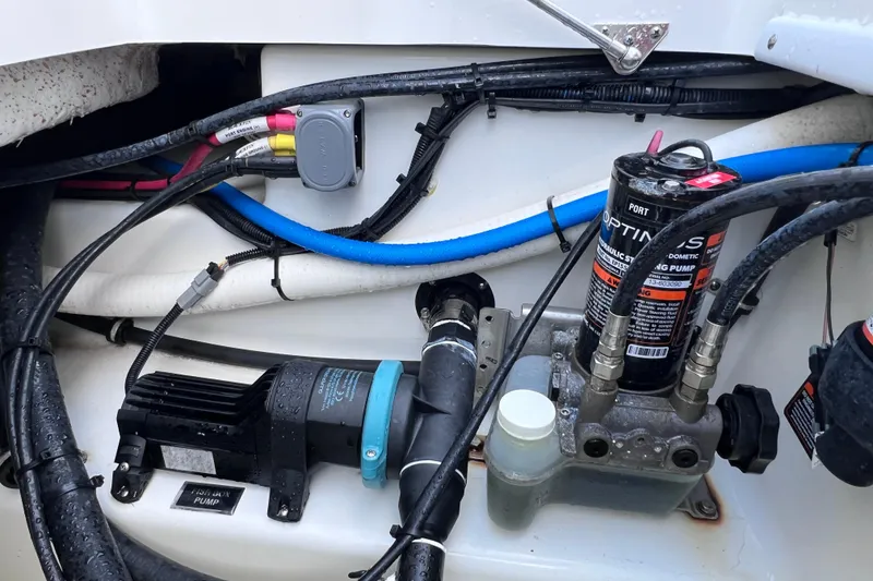 Slide: The Image of Engine compartment of a 2022 Blackfin 272 DC boat with hydraulic steering components. - 94