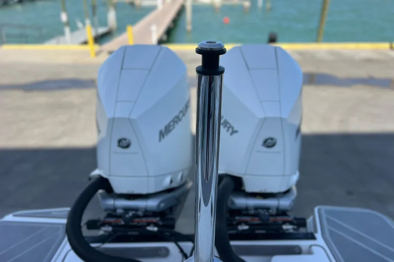Slide: The Image of 2022 Blackfin 272 DC boat with dual Mercury outboard engines at a dock. - 95