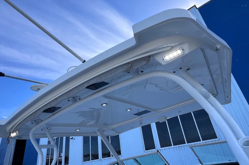 Slide: The Image of 2022 Blackfin 272 DC boat canopy with integrated lighting against blue sky. - 97