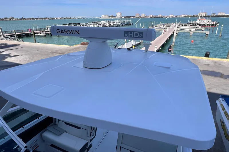 Slide: The Image of 2022 Blackfin 272 DC boat with Garmin xHD2 radar, docked at a marina. - 99