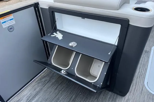 Slide: The Image of Open storage compartment on 2026 Godfrey Monaco 235 SFLC boat with dual bins. - 14