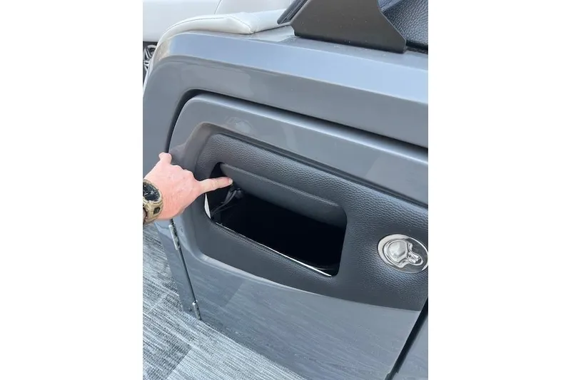Slide: The Image of Hand opening storage compartment on 2026 Godfrey Monaco 235 SFLC boat. - 16