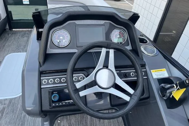 Slide: The Image of 2026 Godfrey Monaco 235 SFLC boat dashboard with steering wheel and control panel. - 17