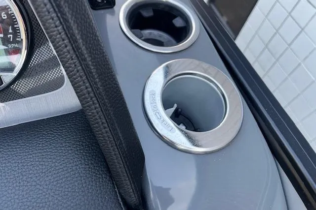 Slide: The Image of 2026 Godfrey Monaco 235 SFLC dashboard with cup holders and gauge detail. - 19