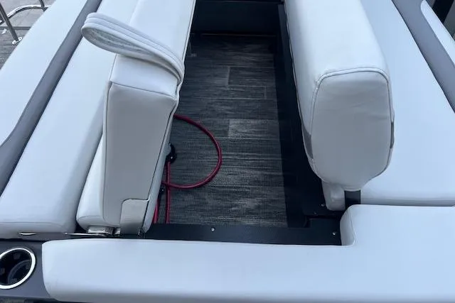 Slide: The Image of 2026 Godfrey Monaco 235 SFLC boat interior with white seating and gray flooring. - 32