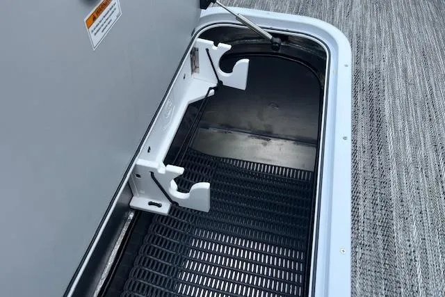 Slide: The Image of Storage compartment of 2026 Godfrey Monaco 235 SFLC boat, featuring secure latch and durable flooring. - 39