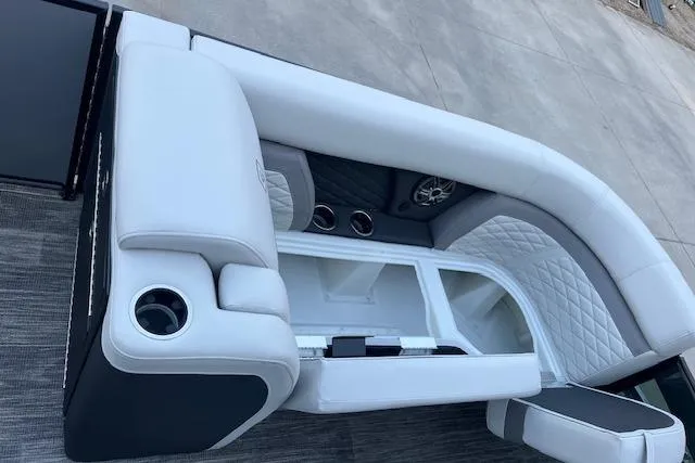 Slide: The Image of 2026 Godfrey Monaco 235 SFLC boat interior with white cushioned seating and cup holders. - 40