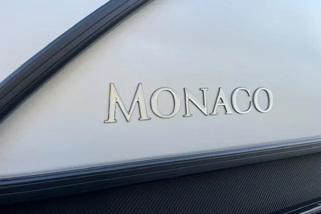 Slide: The Image of 2026 Godfrey Monaco 235 SFLC boat logo on sleek exterior surface. - 8