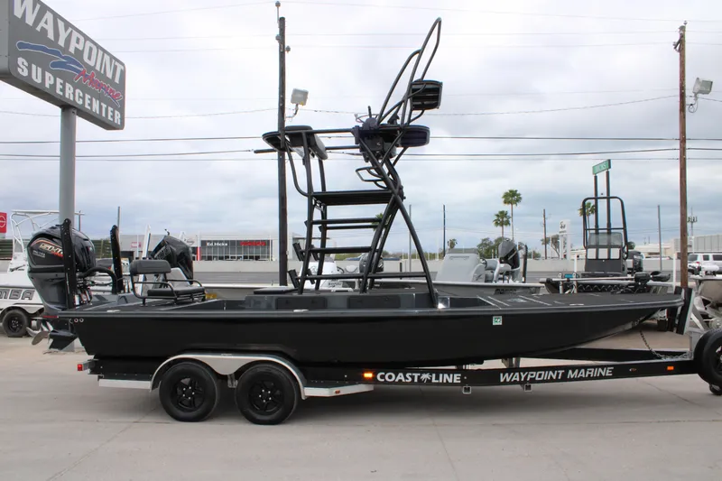 Slide: The Image of 2025 Mamba 24 Catamaran Elite with elevated seating against cloudy sky backdrop. - 11